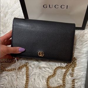 Black gucci purse with gold chain. Worn only 4 times. Still New And  Clean.